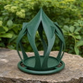 Forest Green Leafspire Haven bird feeder on a natural stone garden ledge