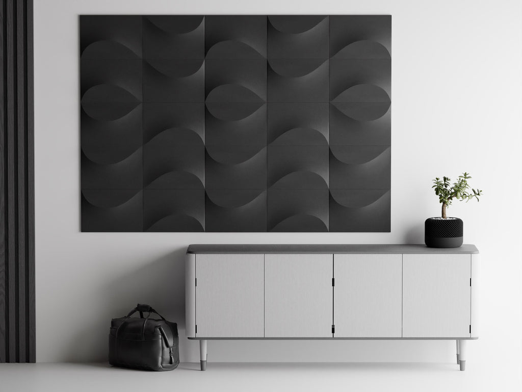 Close-up charcoal TideFold relief tile arrangement mounted above a modern console
