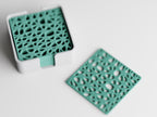 Overhead close-up of the CanopyLace botanical lattice pattern and coordinating holder