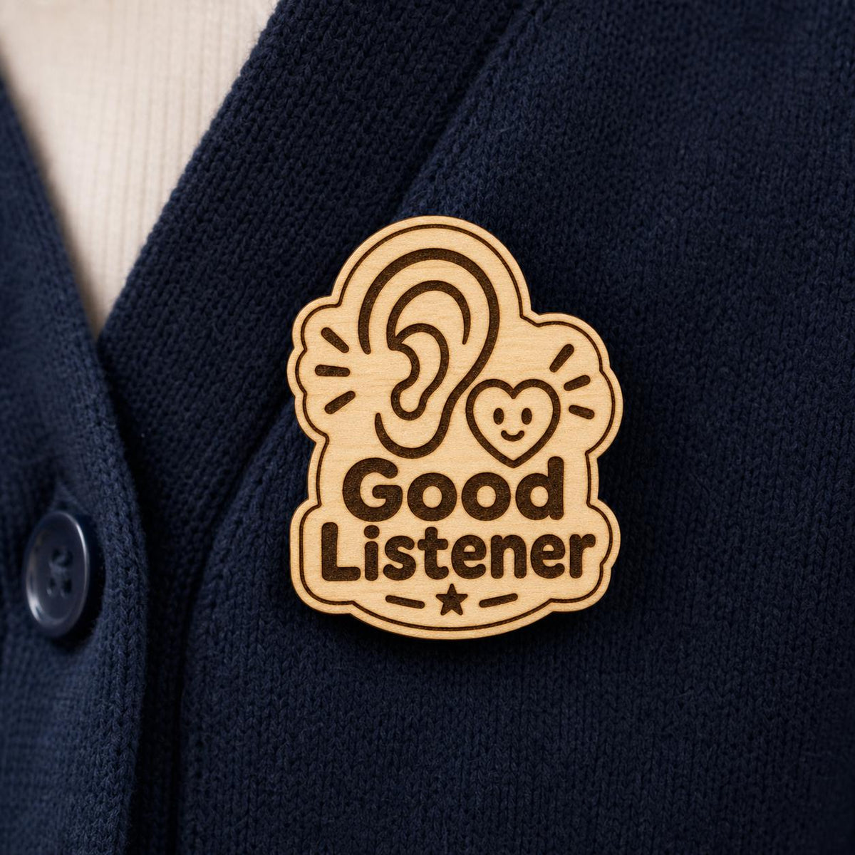 Listening Heart engraved birch reward badge shown close up in a realistic meeting setting.