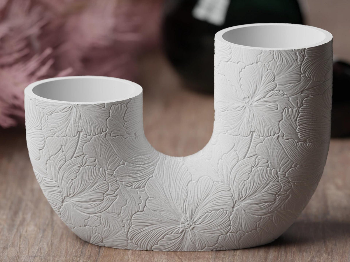 Close-up front view of the Hibiscus Bloom BloomArc twin vase and its broad botanical relief