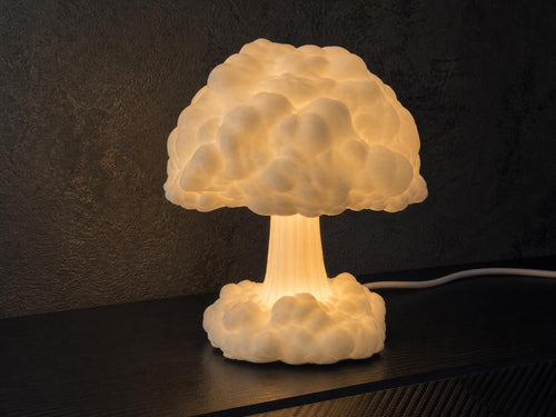 Ivory White Atomic Bloom mushroom cloud lamp glowing on a retro game room desk