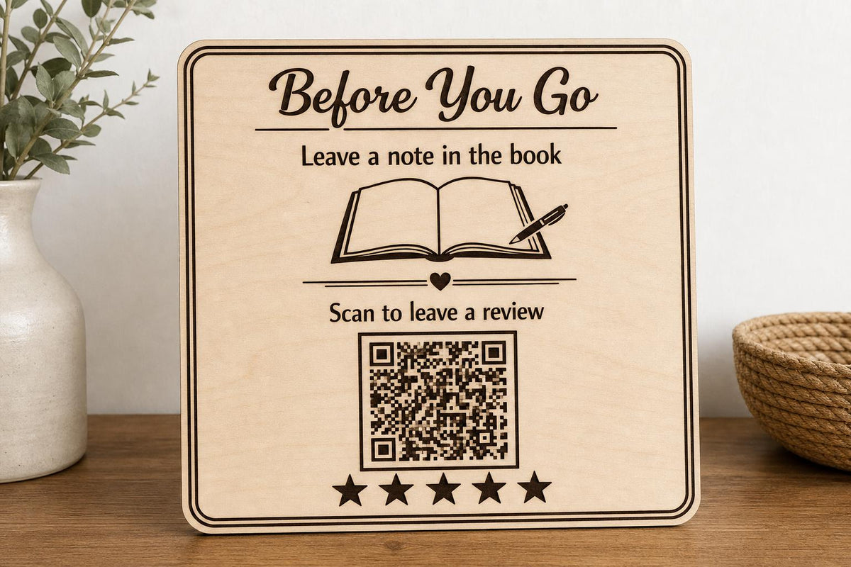Guestbook Glow engraved birch review sign upright on a welcoming entry console with a finished sample QR code.