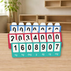 Three red, blue, and teal MeasureMap metric boards arranged closely on a light wood classroom table, with white number tabs and black numerals.