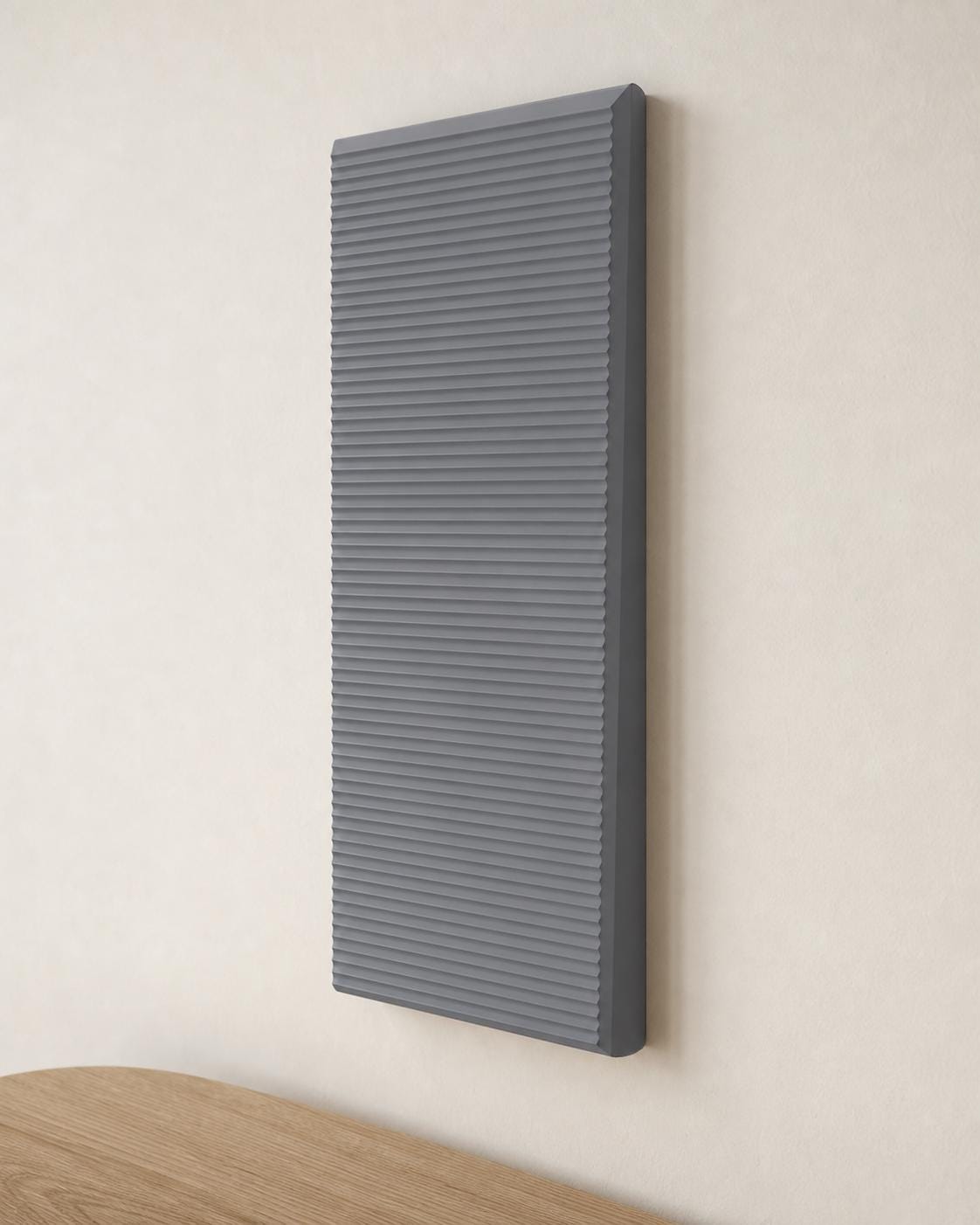 Close-up Nardo Gray RidgeLoom sculptural wall tile mounted vertically on a warm neutral wall