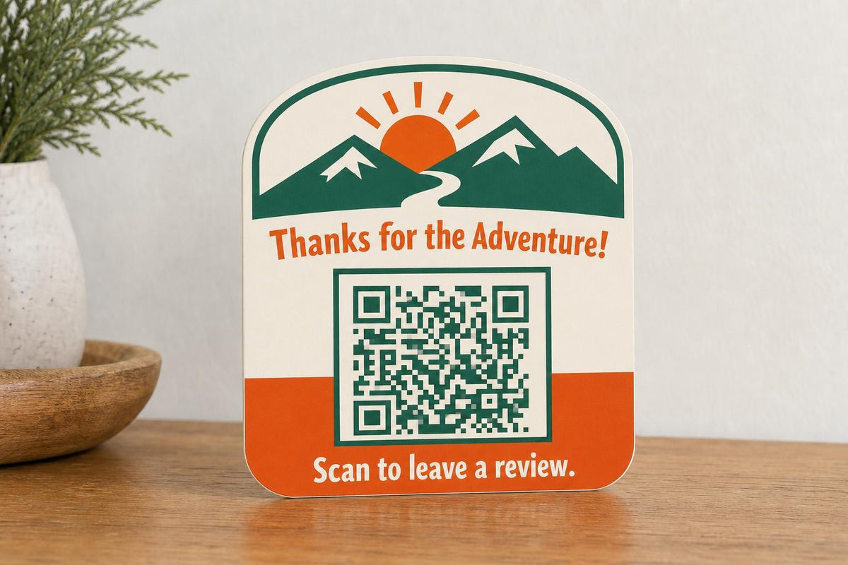 SummitGlow multicolor mountain guest review sign upright on a cabin entry console with a finished sample QR code.