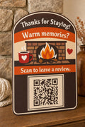 EmberHearth multicolor fireside guest review sign upright near a cozy hearth with a finished sample QR code.
