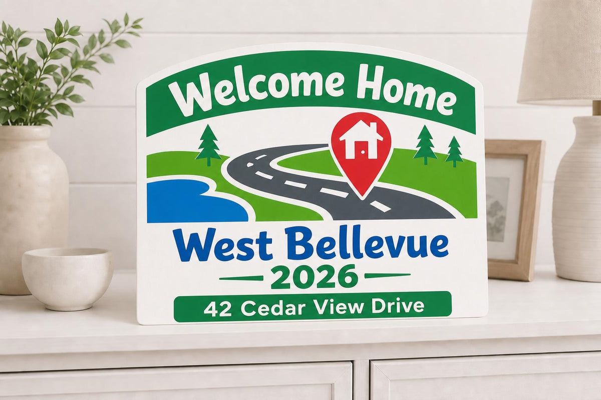 Welcome Home colorful road sign shown close up with West Bellevue, 42 Cedar View Drive, a location pin, and 2026.