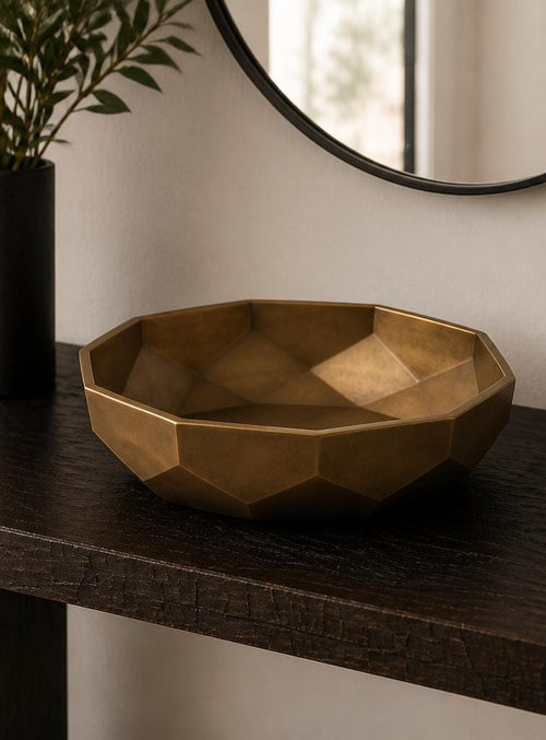 Anglewell entry bowl in bone white, three-quarter close-up on a warm wood console holding keys and a wallet.