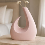 MoonGate Statement Vase, close-up lifestyle view of the Solstice Arc vase in Sakura Pink with dried white stems