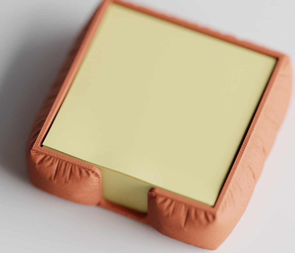 High-angle close-up of the MemoNook Pad Holder square sticky note holder in Terracotta