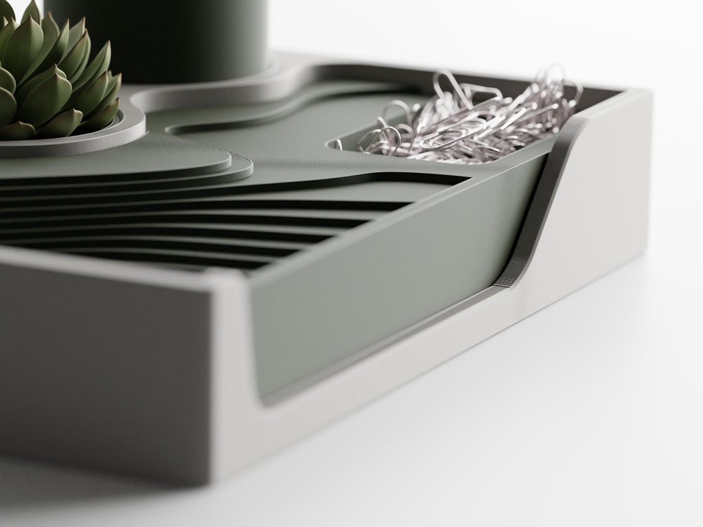 Right-side close-up of the Landform Desk Station catchall tray, low round well, and sculpted front opening