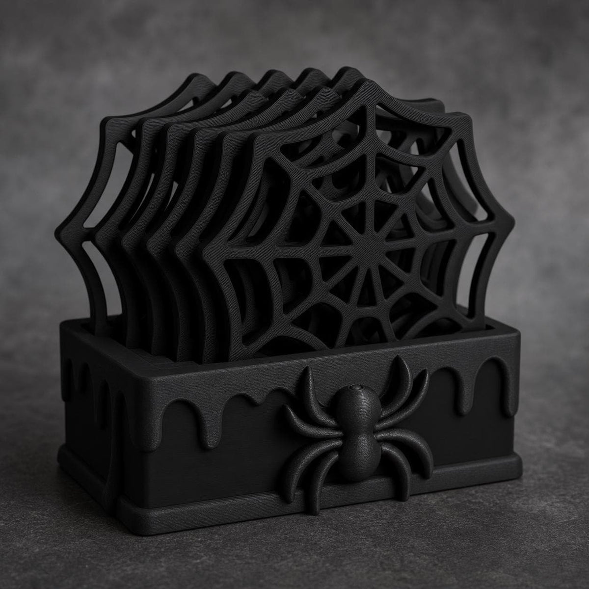 Close-up of the complete Black WebWarden gothic spider coaster set with five web coasters stored in the holder