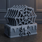 Close-up of the complete Blue Grey WebWarden spider coaster set with all five coasters stored upright