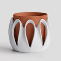 Arcloom planter in Dune with speckled White Marble outer arches and a Terracotta inner pot, close-up on a pale gray background.