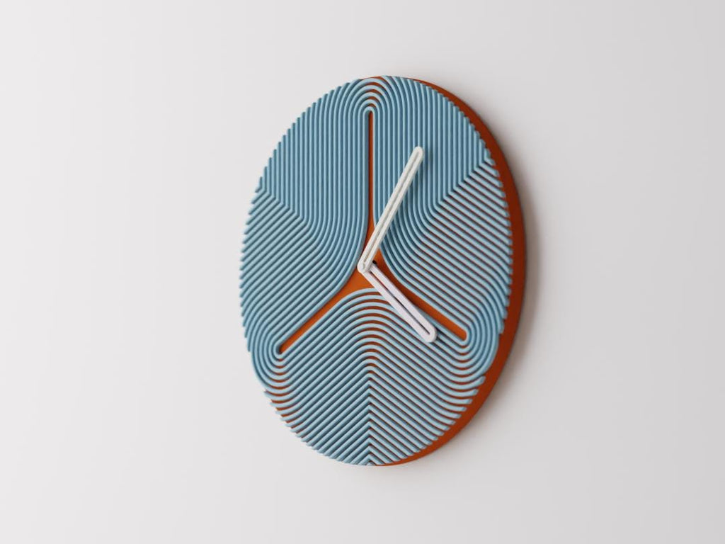 Triripple Wall Clock, blue curved ribs over a rust-colored round face with white hands, mounted on a pale wall in an angled view.