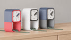 Keephour Watch Stand Clock colorful examples from an alternate source angle on oak, with watches with green bands in the lower spaces.