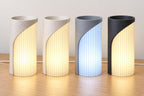 Four neutral Caldora colorways, left to right: Marble Glow, Linen Glow, Slate Frost and Midnight Glow, with full-height ribbed diffusers.