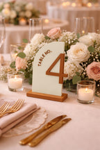 Bone White half-arch Table No. 4 sign with Caramel raised number, lettering, and base on a wedding table with flowers and candles.