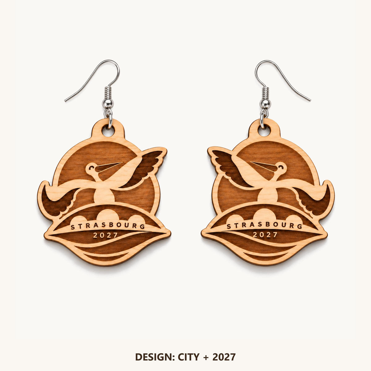 Front view of the Strasbourg City + 2027 engraved birch earring pair on a light background.