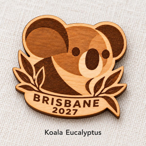 Close-up of Brisbane Koala Eucalyptus engraved birch pin on linen, with design name caption.