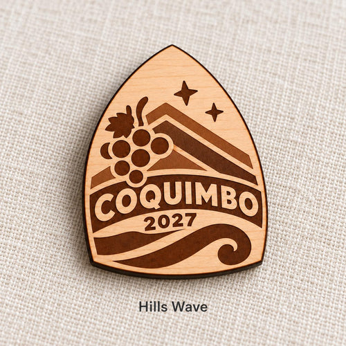 Close-up of Coquimbo Hills Wave engraved birch pin on linen, with design name caption.
