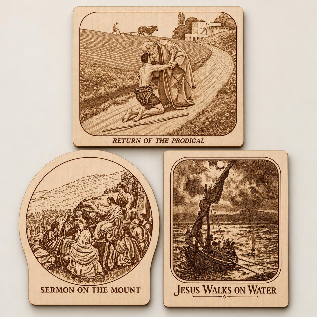 Three natural birch Photo-Drama plaques displayed together on a plain light background, showing different engraved historical scenes.